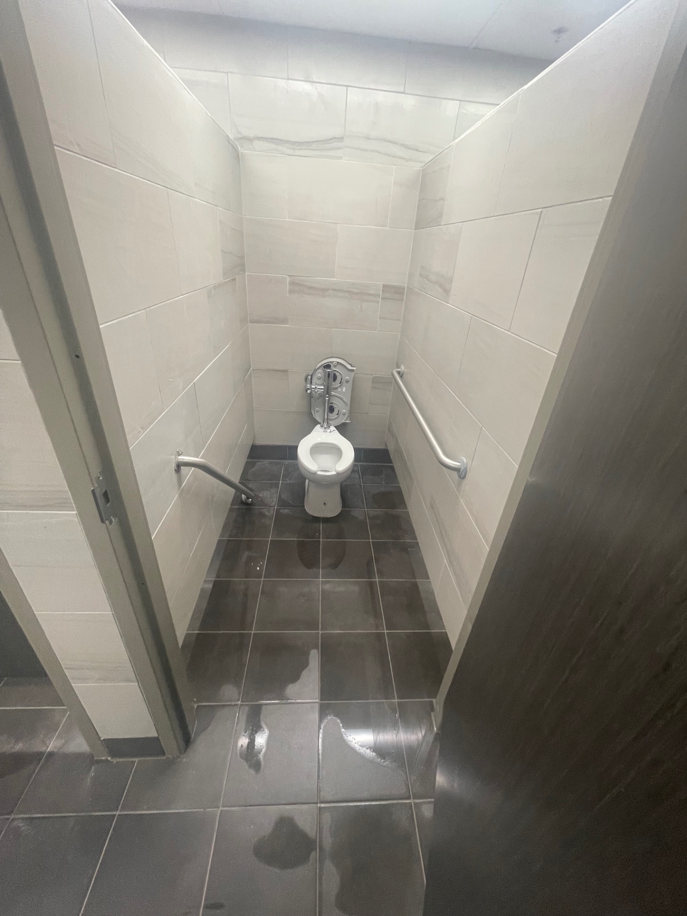 Cleaned accessible restroom stall with tile walls and floor