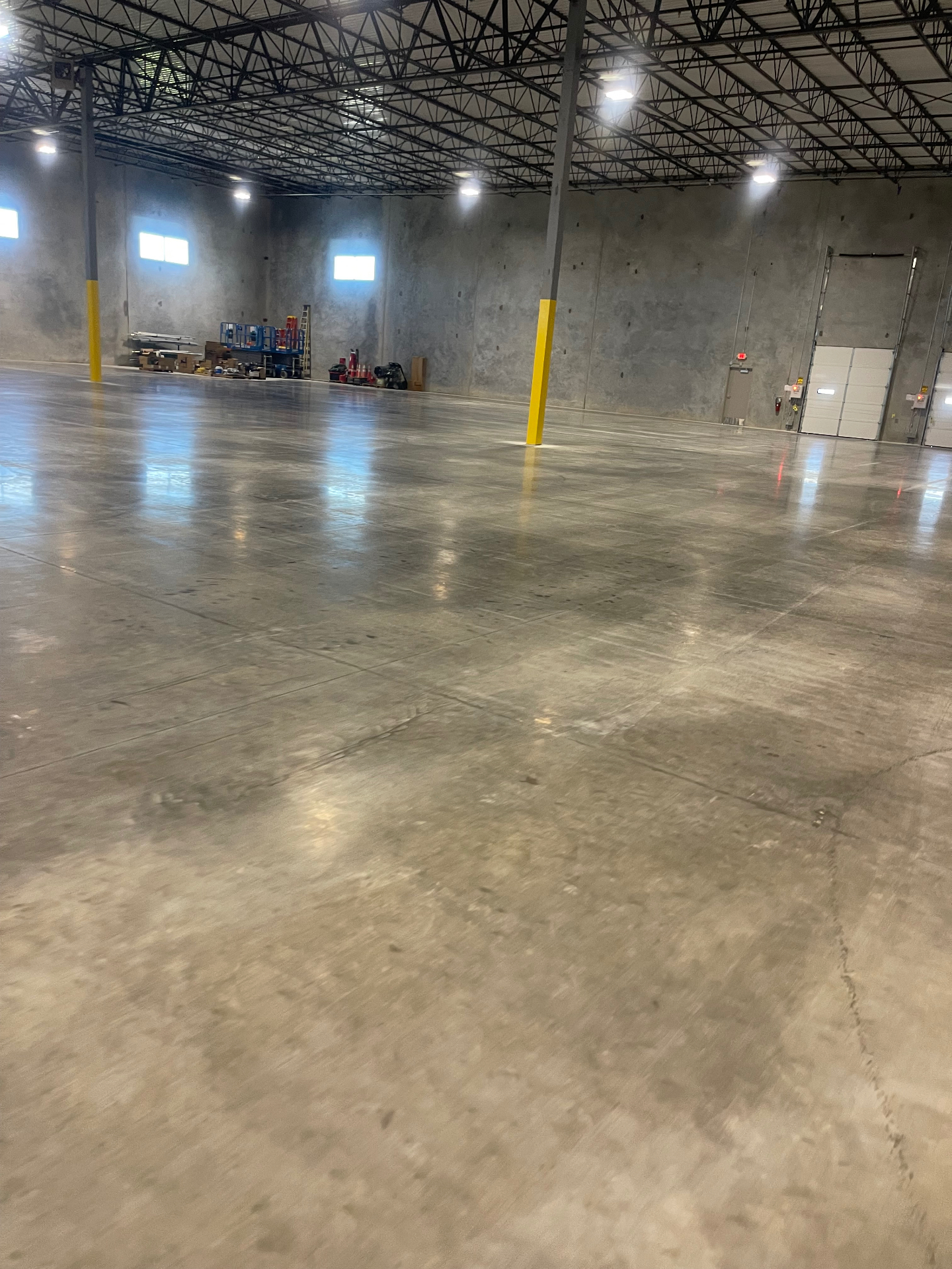 Cleaned warehouse floor near an overhead loading door