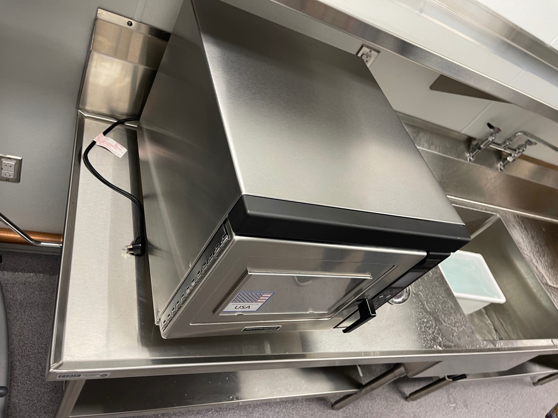 Project documentation photo of kitchen equipment on a stainless prep table