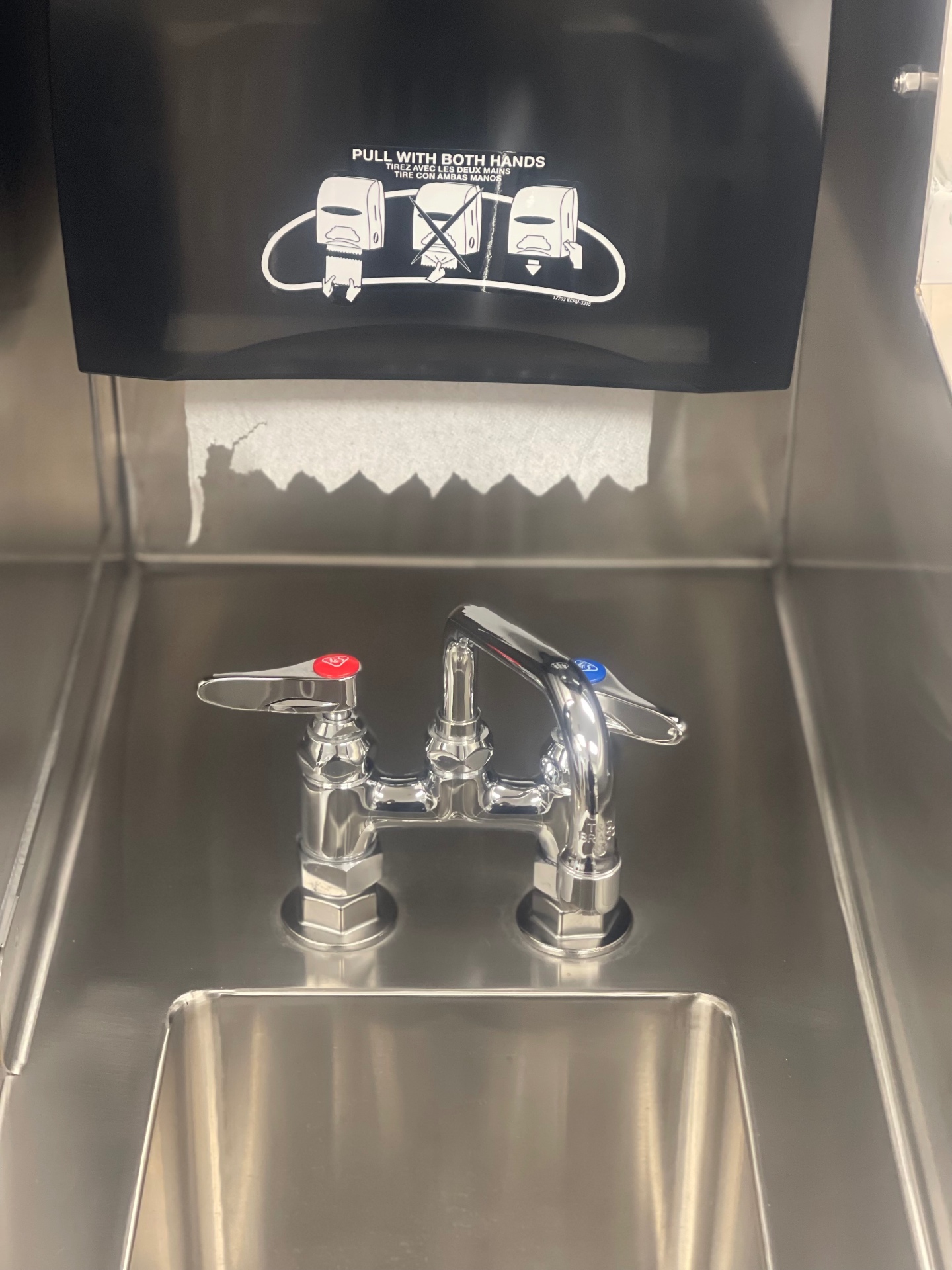 Stainless hand-wash station with towel dispenser after cleaning