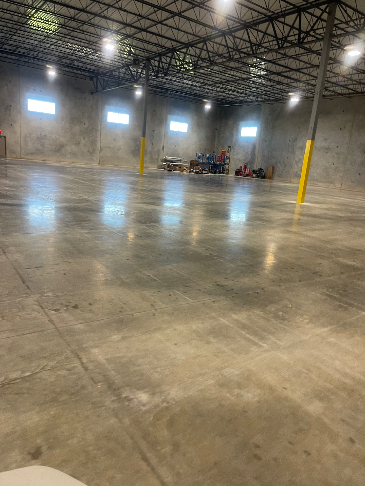Wide view of the cleaned warehouse floor and concrete walls