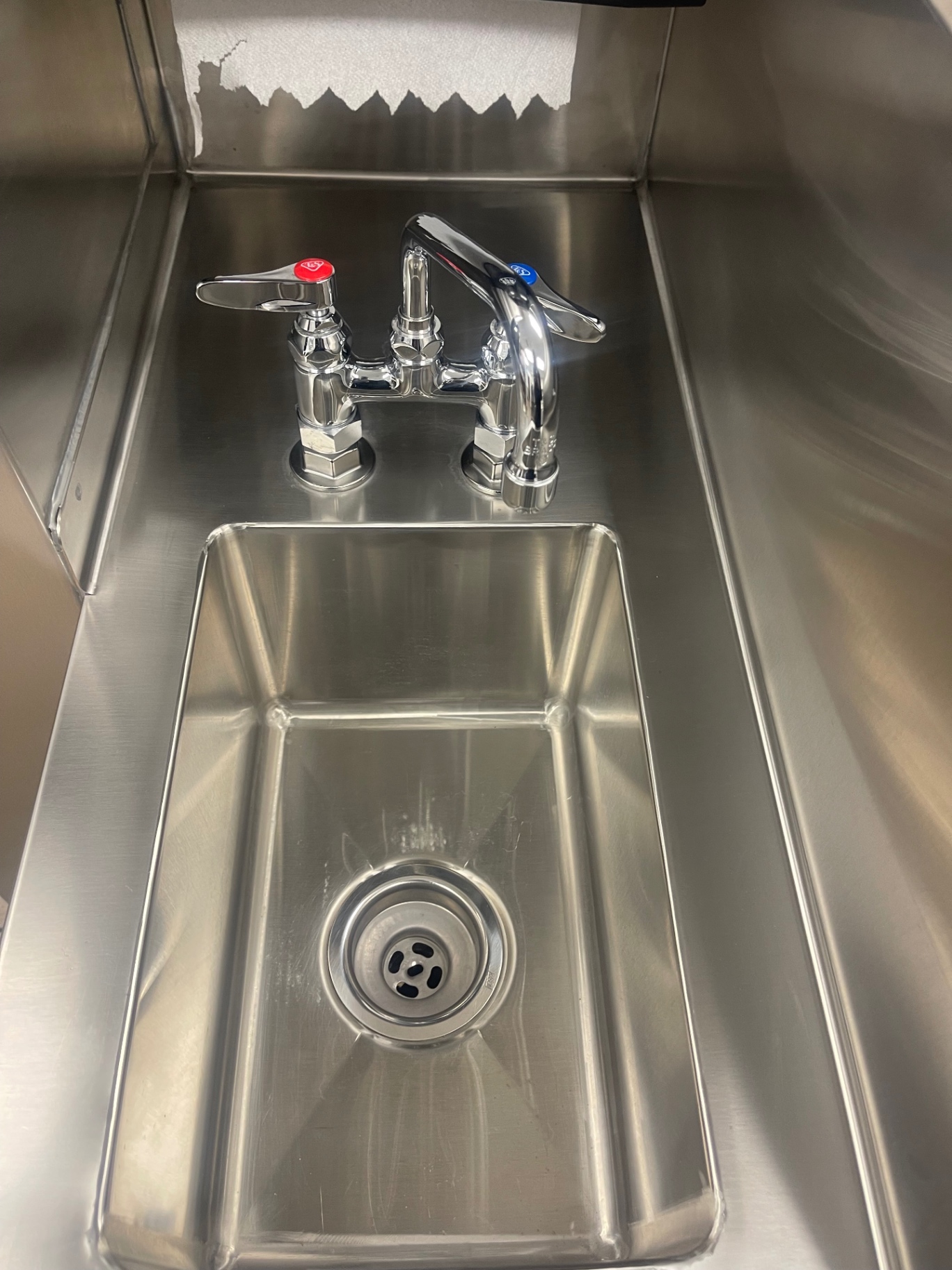 Cleaned stainless hand-sink basin and faucet