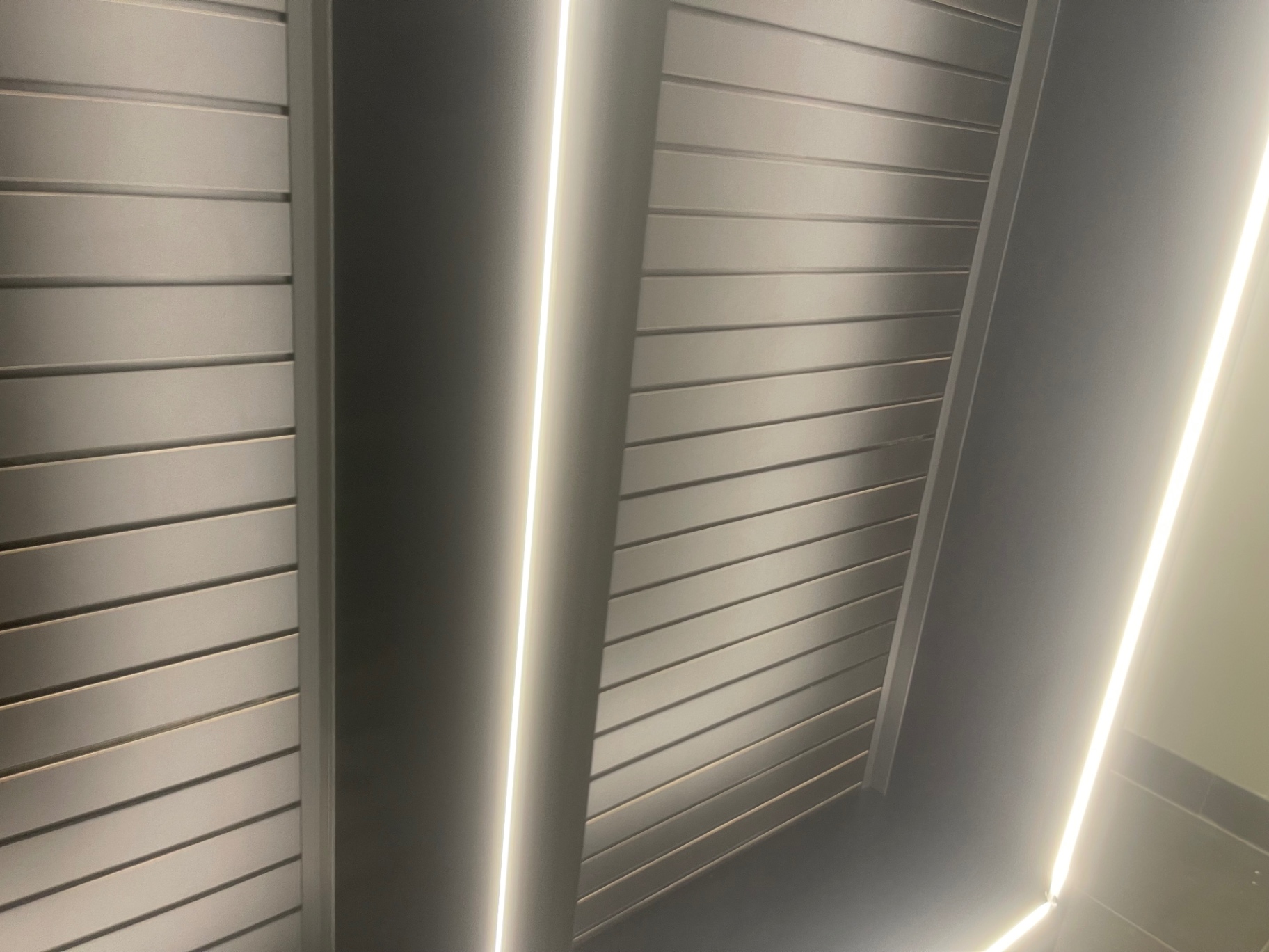 Overhead metal ceiling slats and light coves after cleaning
