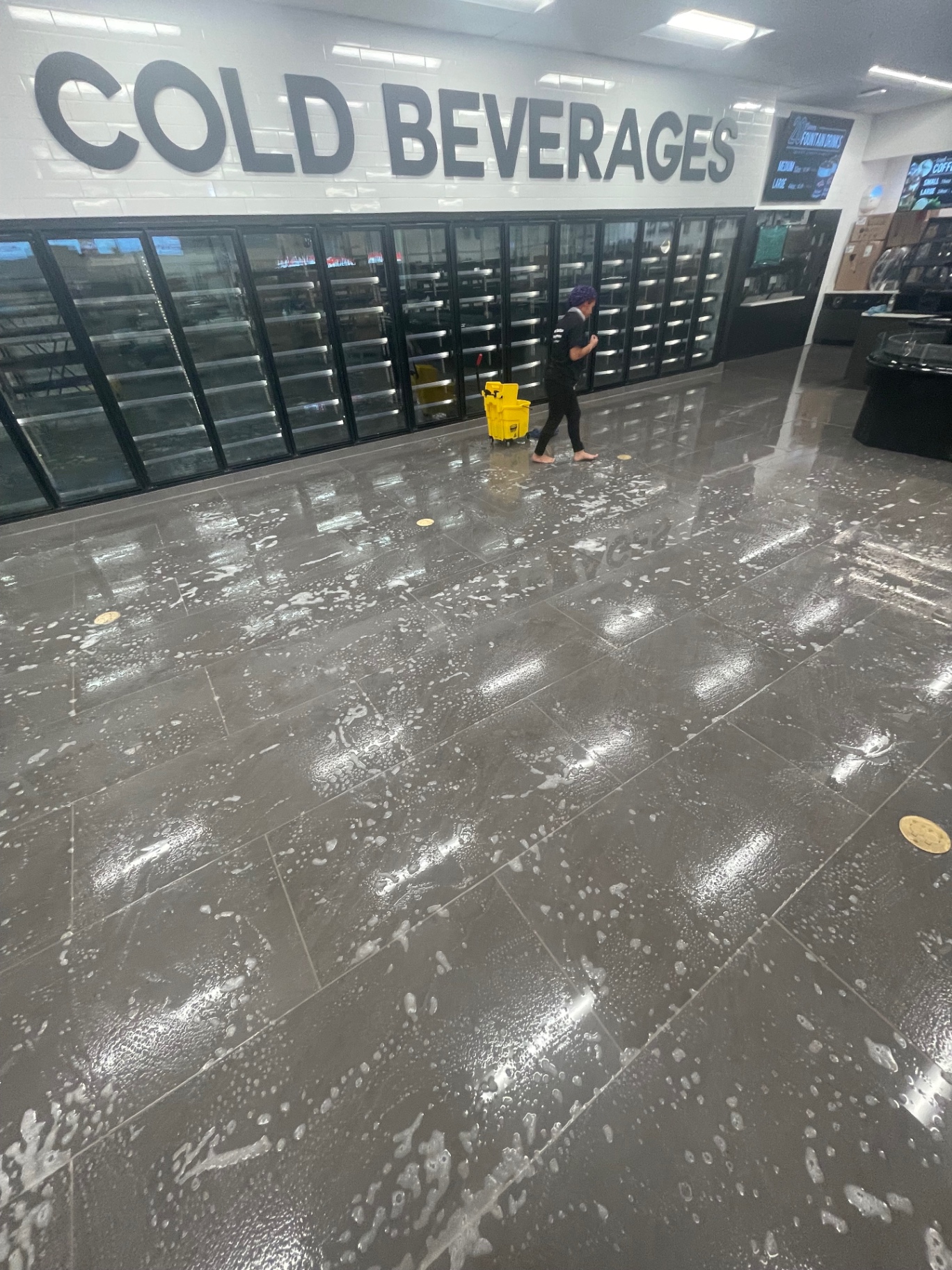 Cold beverage cooler line with freshly scrubbed tile floor
