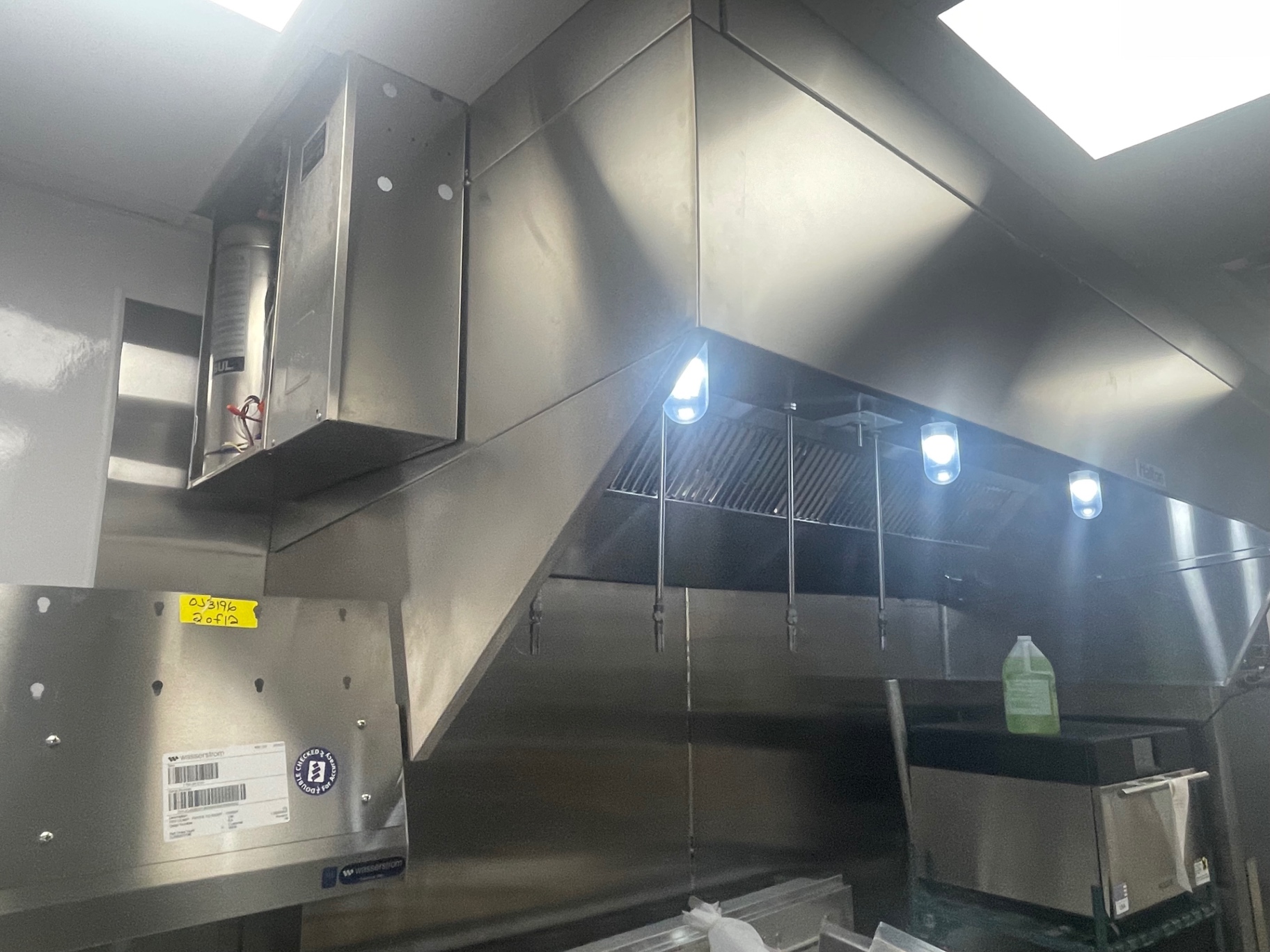 Stainless exhaust hood and canopy surfaces cleaned above the cook line
