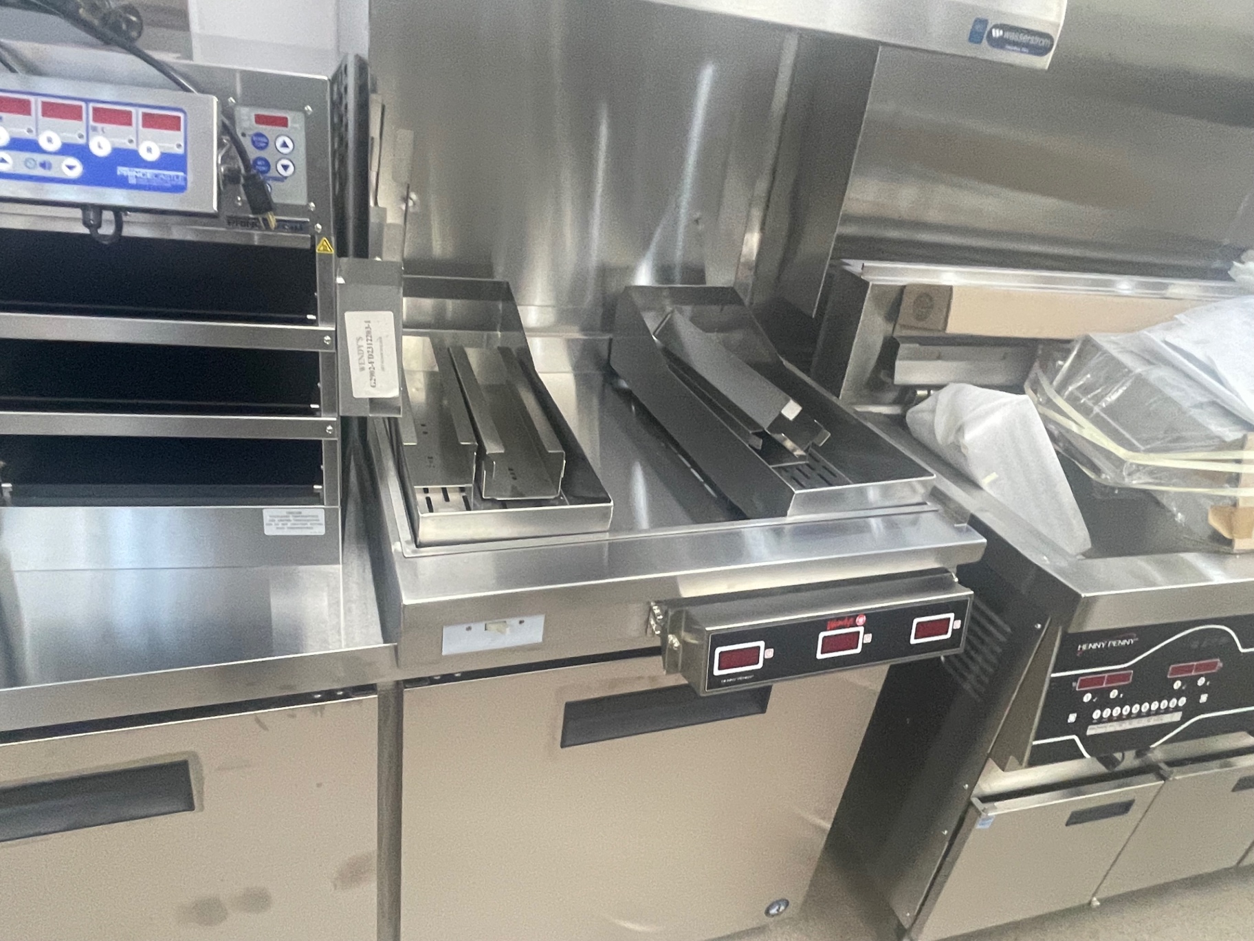 Cleaned stainless holding units and griddle station on the cook line