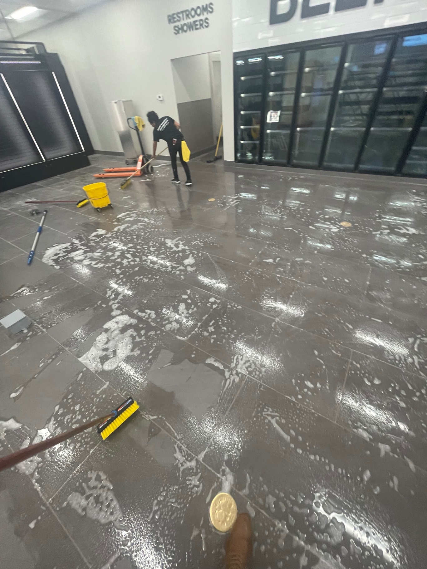 Store aisle beside cooler doors during floor scrubbing