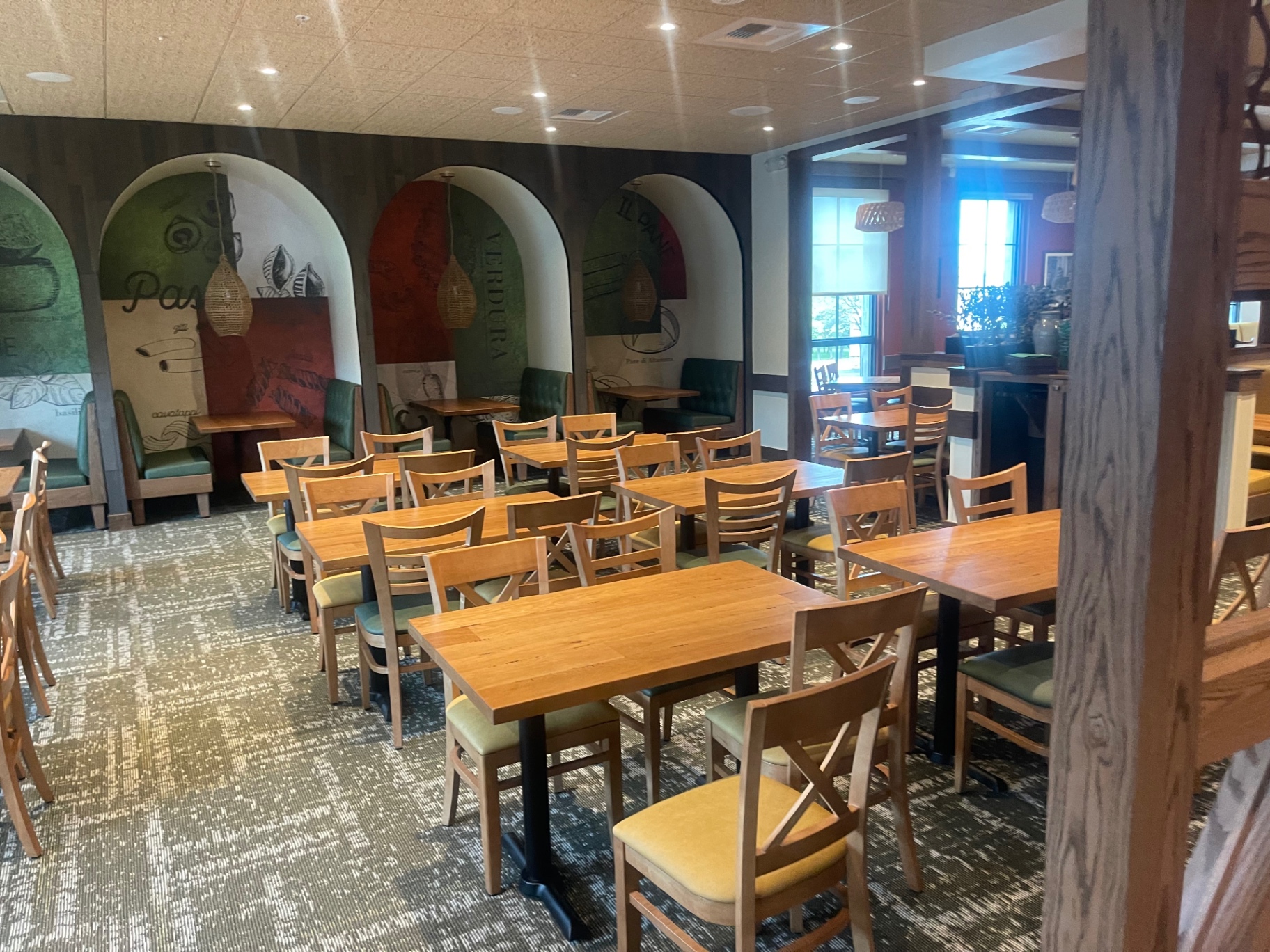 Rows of cleaned dining tables and chairs on carpeted floor